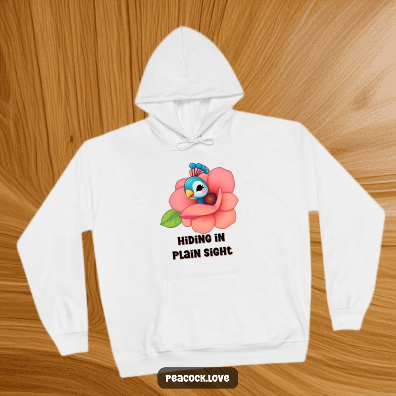 Funny Kawaii Peacock Hoodie: A curious peacock peeks from behind a flower, offering a playful wink, embodying cozy mystery.